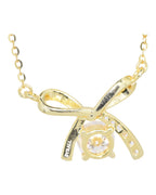 Close-up 0.5ct VVS1 round brilliant moissanite in gold bow pendant necklace by Byrall
