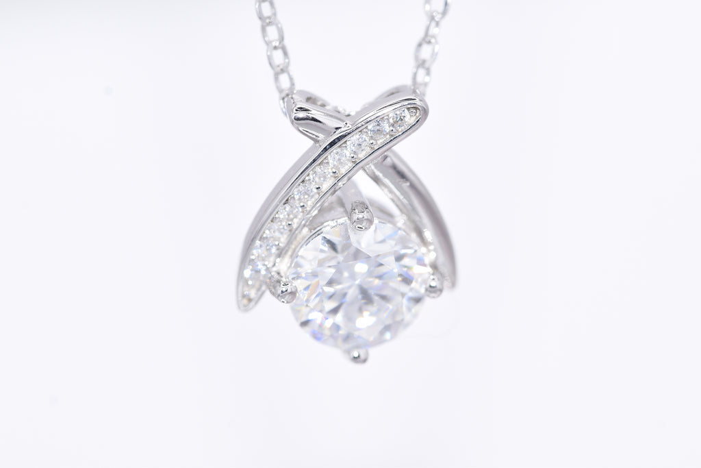 Close-up 1ct VVS1 round brilliant moissanite pavé ribbon wrap pendant rhodium silver — Byrall Jewellery