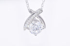 Close-up 1ct VVS1 round brilliant moissanite pavé ribbon wrap pendant rhodium silver — Byrall Jewellery