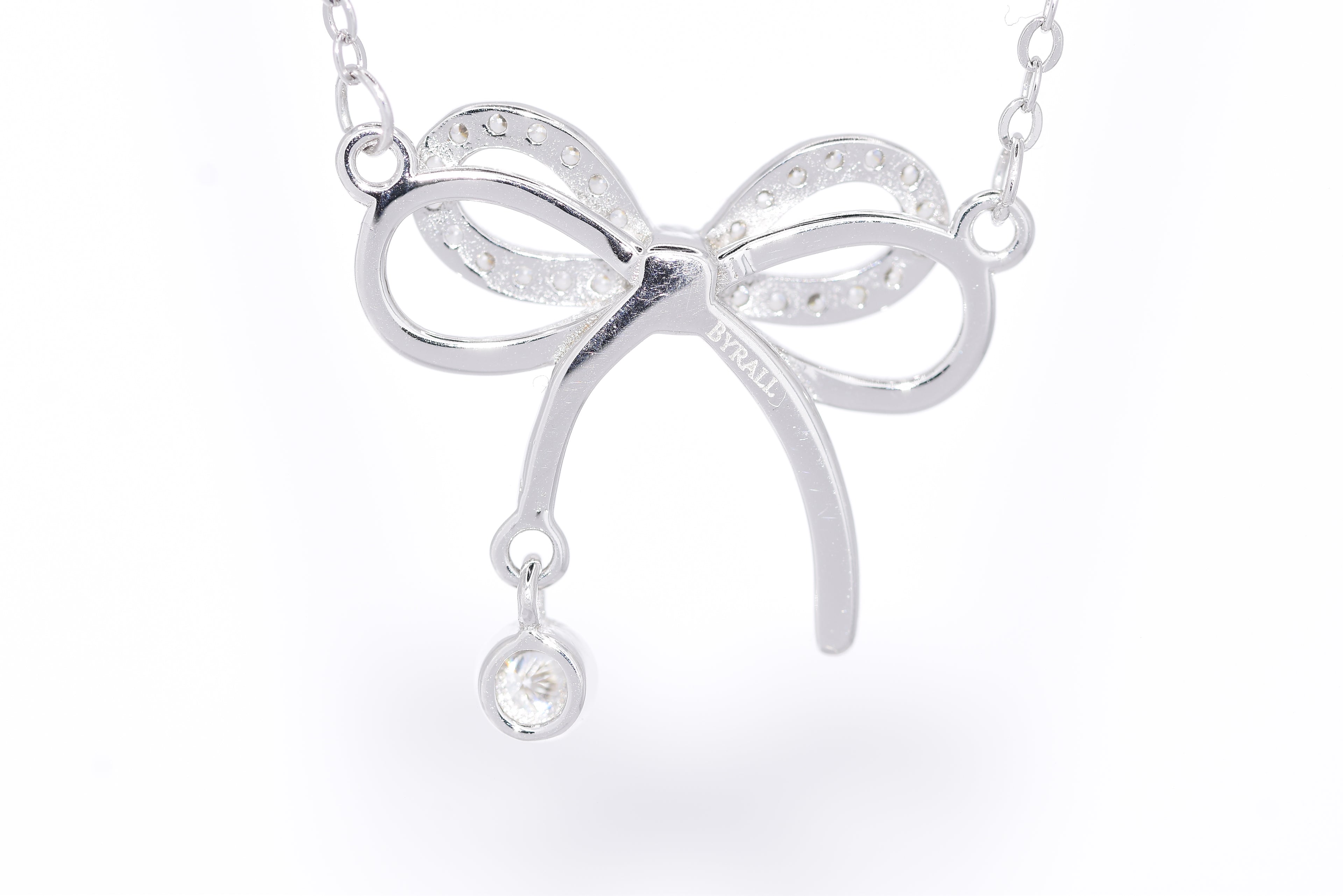 Close-up pavé moissanite bow with bezel drop rhodium silver S925 dainty necklace — Byrall Jewellery