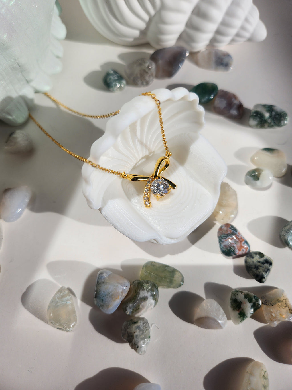 Woman wearing Gold Aurora bow moissanite necklace, delicate gold pendant Australia gift for her