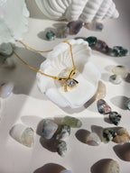 Woman wearing Gold Aurora bow moissanite necklace, delicate gold pendant Australia gift for her